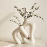 Modern abstract ceramic vase with dried eucalyptus branches